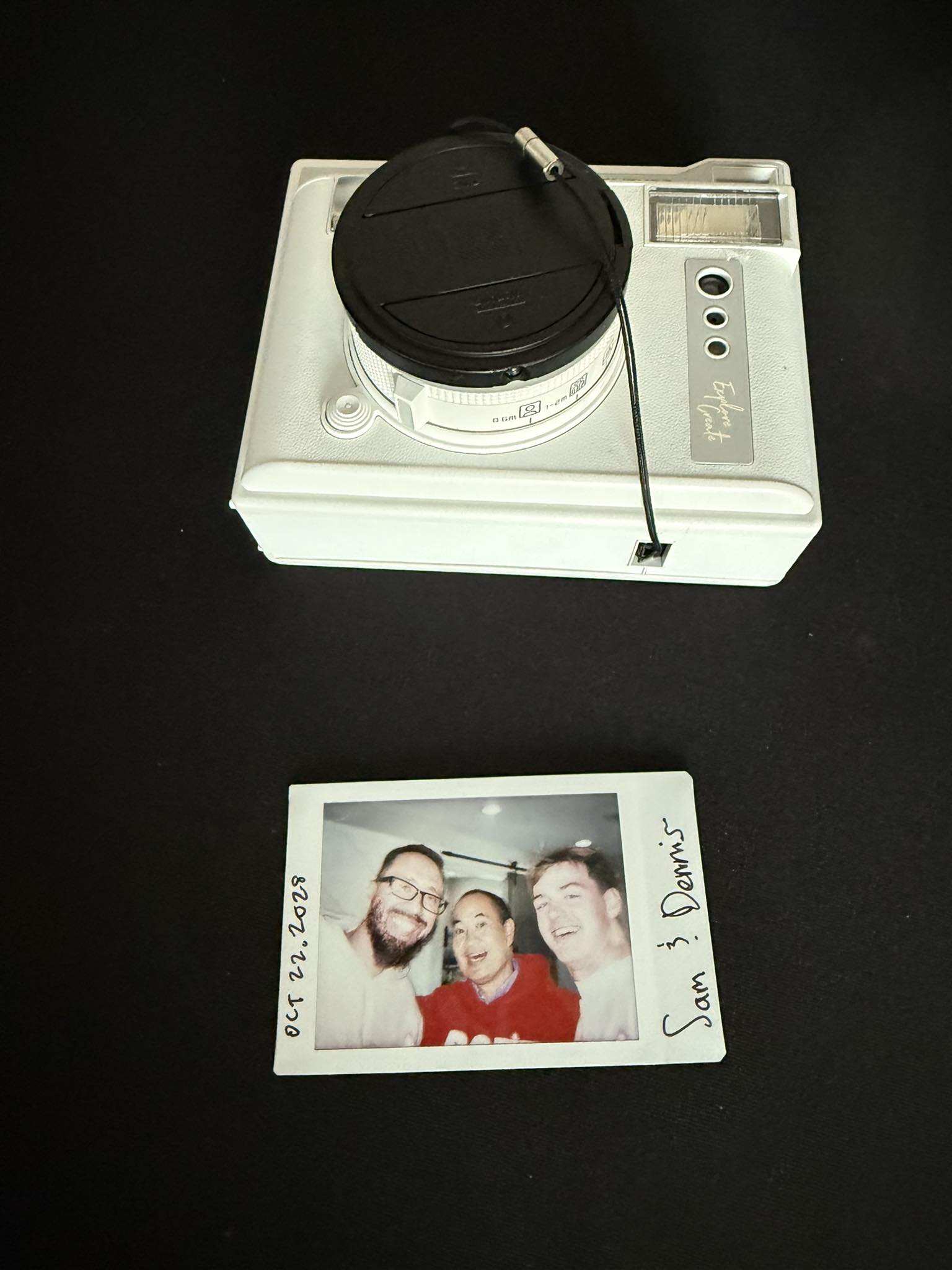 Polaroid of Damon Burton, Dennis Yu in a red hoodie, and Sam McLeod from the same day as the Local Service Spotlight podcast in Damon’s office. The year written on the print is not 2023.