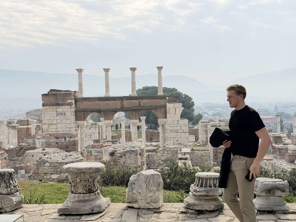 How We Built a First-Person Biblical Travel Article Using AI Agents 2 Danny Leibrandt standing among ancient columns at Ephesus ruins in Turkey