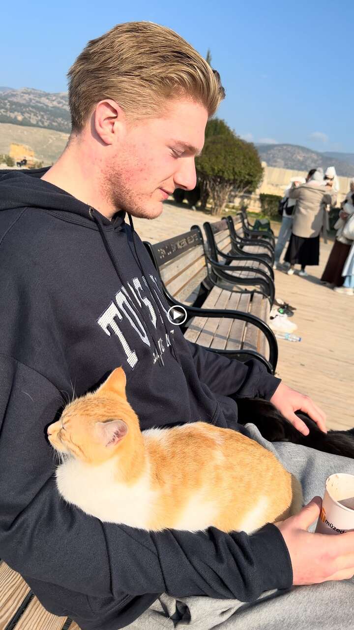 Walk Where the Apostles Walked: 23 Days Through Turkey's Biblical Sites 8 Danny Leibrandt with orange cat at archaeological site in Turkey during Seven Churches of Revelation trip