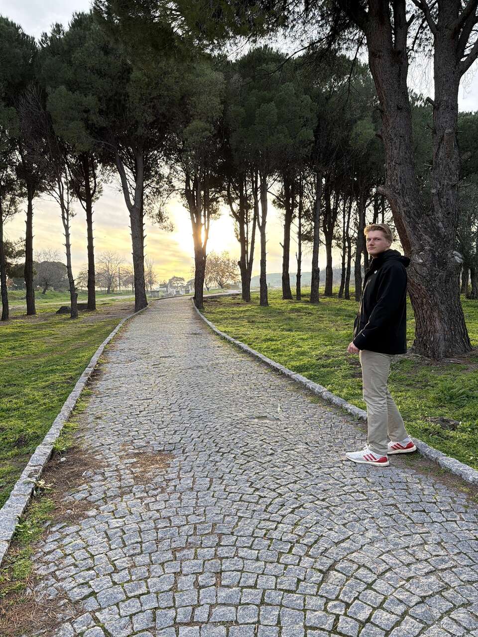 Walk Where the Apostles Walked: 23 Days Through Turkey's Biblical Sites 1 Danny Leibrandt on cobblestone tree-lined path at sunset near Turkish archaeological site