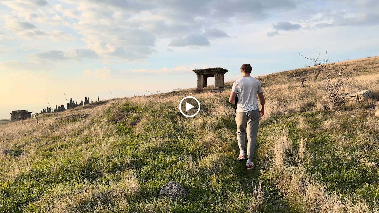 Walk Where the Apostles Walked: 23 Days Through Turkey's Biblical Sites 4 Walking toward stone ruins on grassy hillside in Turkey biblical sites trip