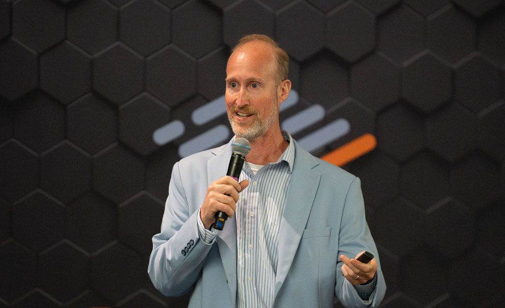 Brian Piper giving a keynote at a higher education conference