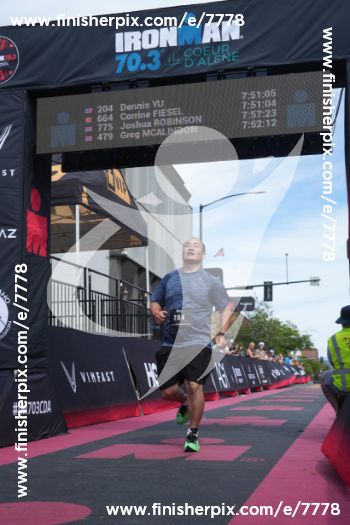 How I Finished an Ironman 70.3 on Zero Training (and a Facebook Marketplace Bike) 5 Dennis Yu crossing the Ironman 70.3 Coeur d'Alene 2024 finish line