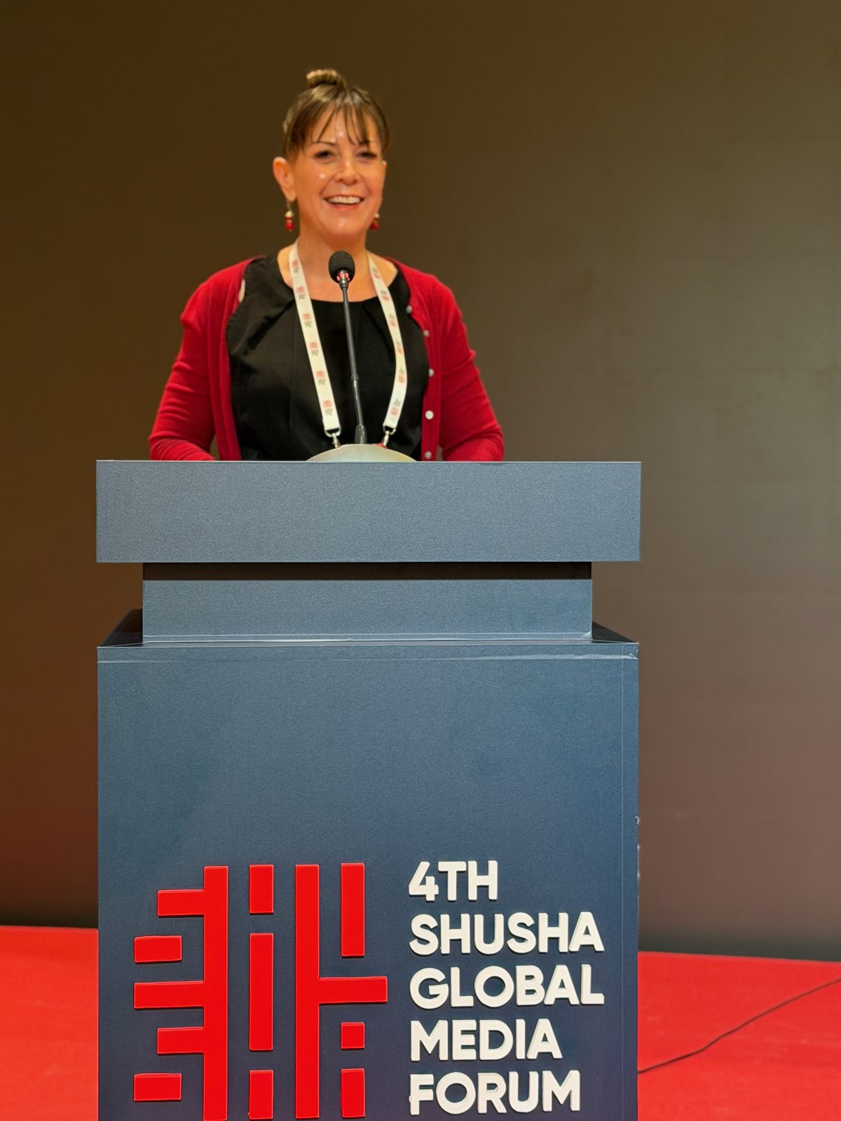Dr. Karen Sutherland speaking at the 4th Shusha Global Media Forum podium, July 14 2026
