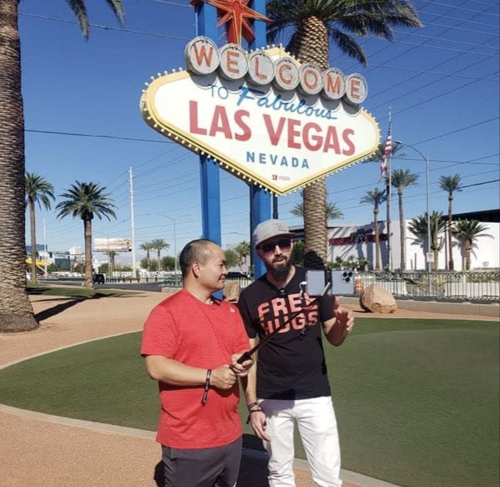 Dennis Yu and Damon Burton in front of the Welcome to Fabulous Las Vegas sign