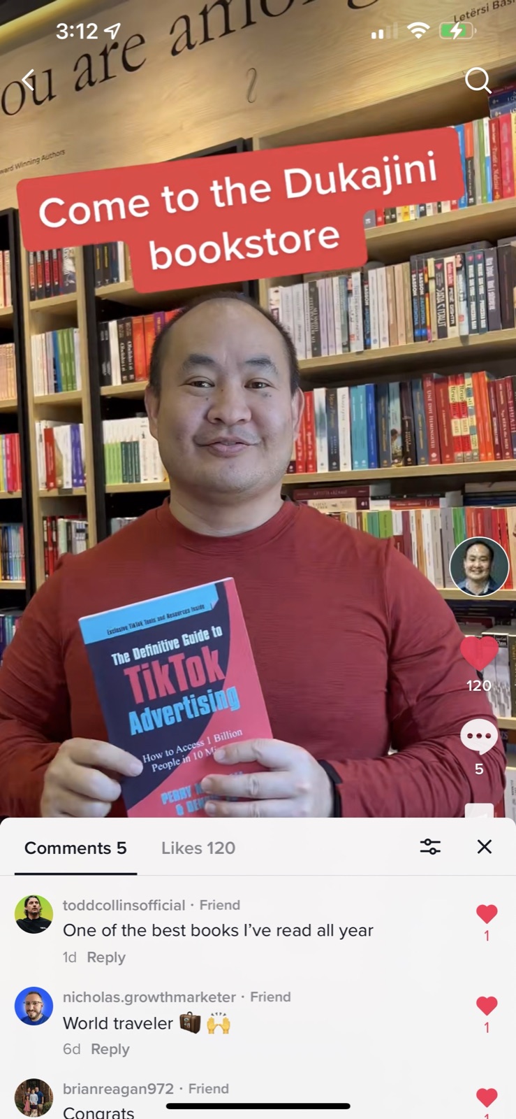 Dennis Yu holding the TikTok book in Dukagjini bookstore with reader comments