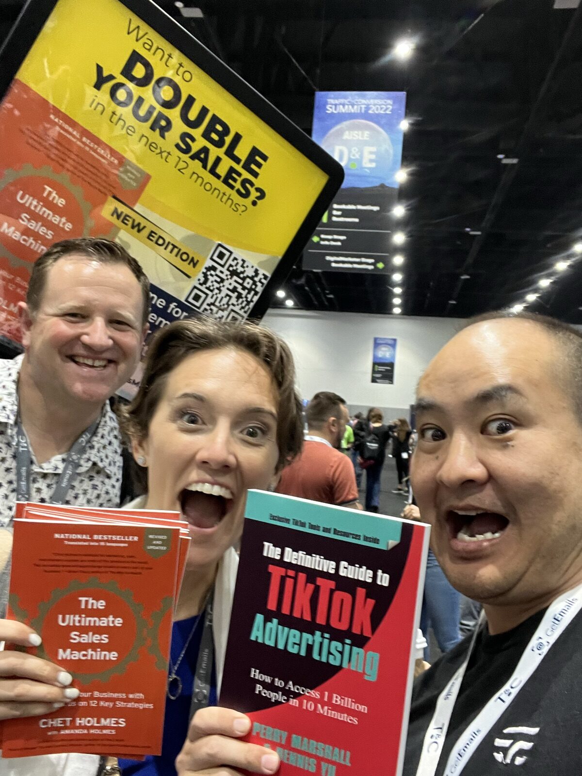 Woman holding the TikTok book on the Traffic and Conversion Summit 2022 exhibit floor