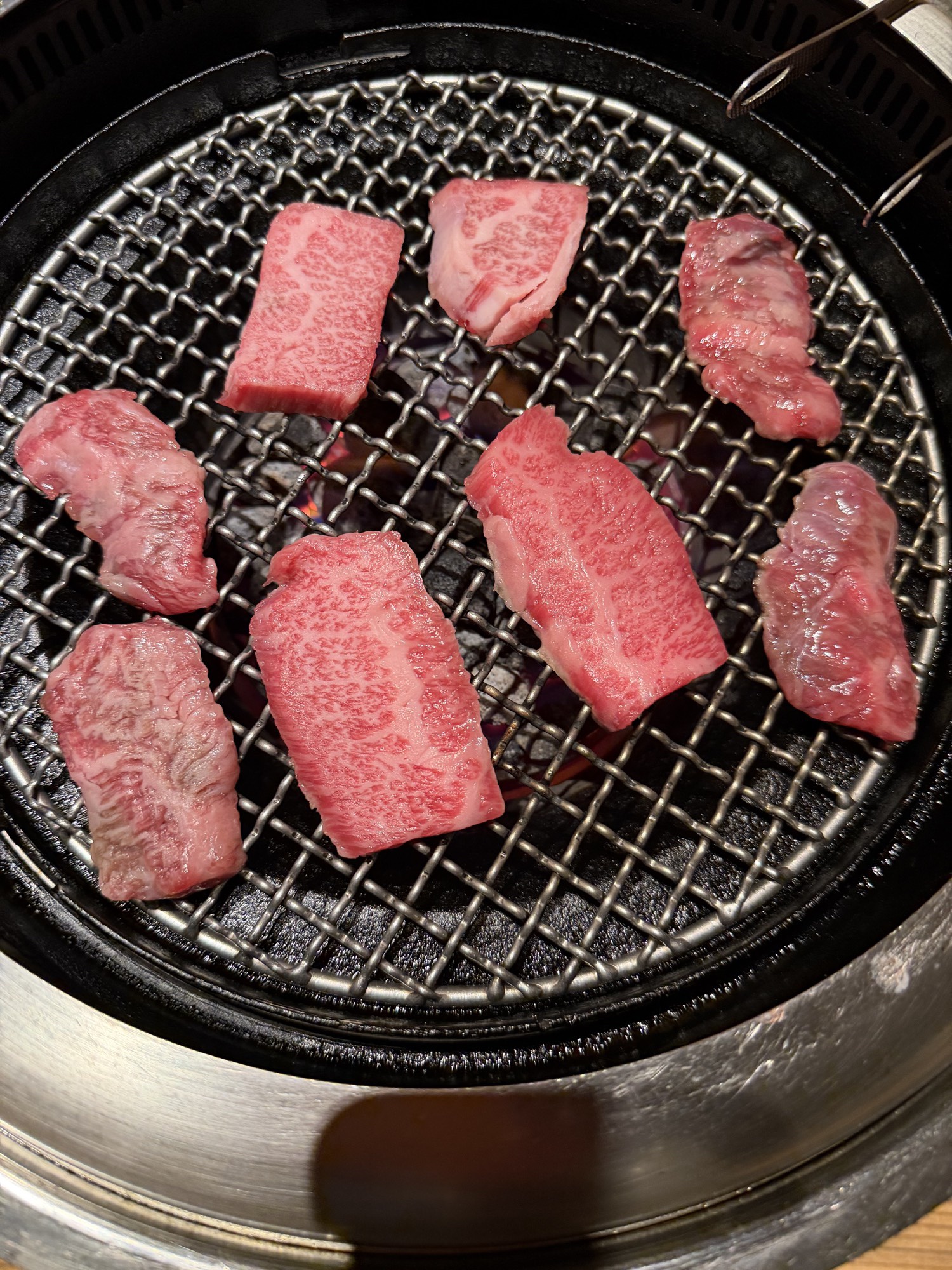 Meatings in Tokyo: Why I Love to EEAT With Good Friends 7 Eight pieces of marbled wagyu searing on the charcoal grill at Yakiniku Black Hole Shinjuku