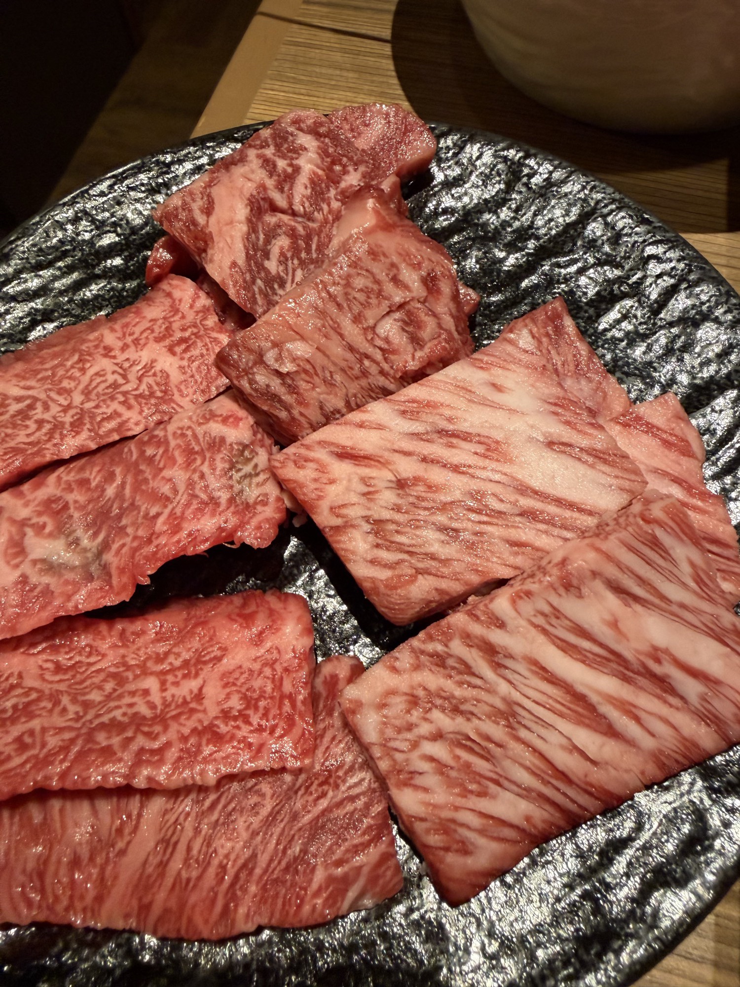 Meatings in Tokyo: Why I Love to EEAT With Good Friends 3 Close-up of thick, heavily marbled wagyu short-rib slices on a black textured plate