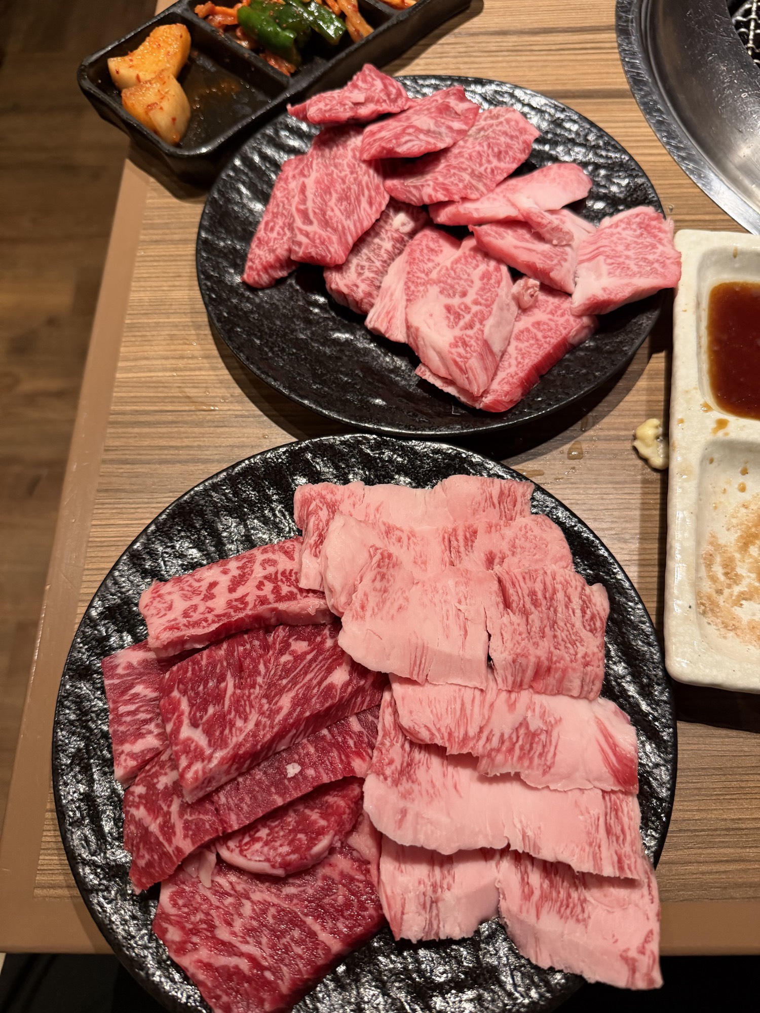 Meatings in Tokyo: Why I Love to EEAT With Good Friends 6 Two large plates of mixed wagyu with kimchi, grilled garlic, and tare sauce on the side