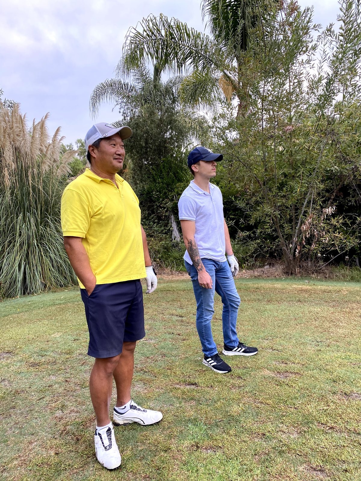 Dennis Yu in a yellow shirt with a friend at Chimera Golf Club in Henderson, Nevada