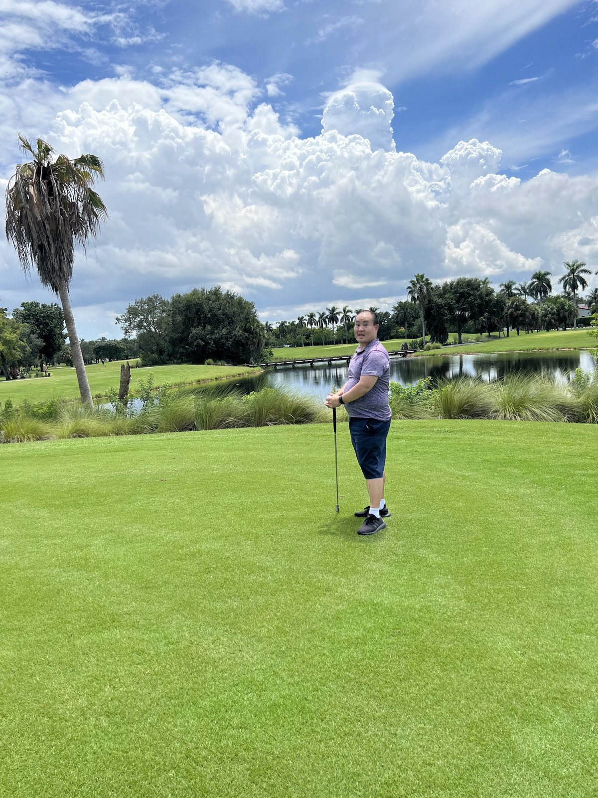 Dennis Yu on a golf course under big clouds, August 2022