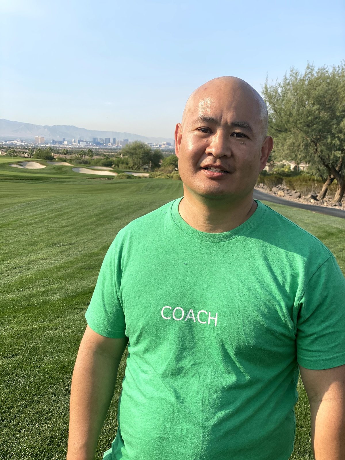 Dennis Yu on the course in a green Coach shirt, October 2020