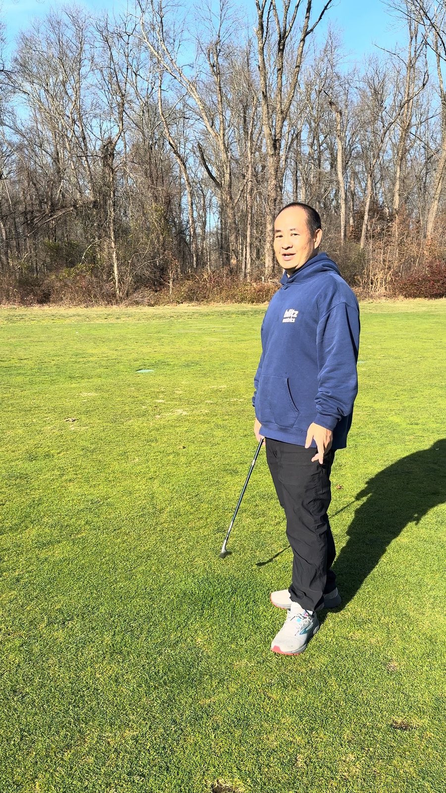 Dennis Yu in a navy hoodie walking a fairway, November 2024