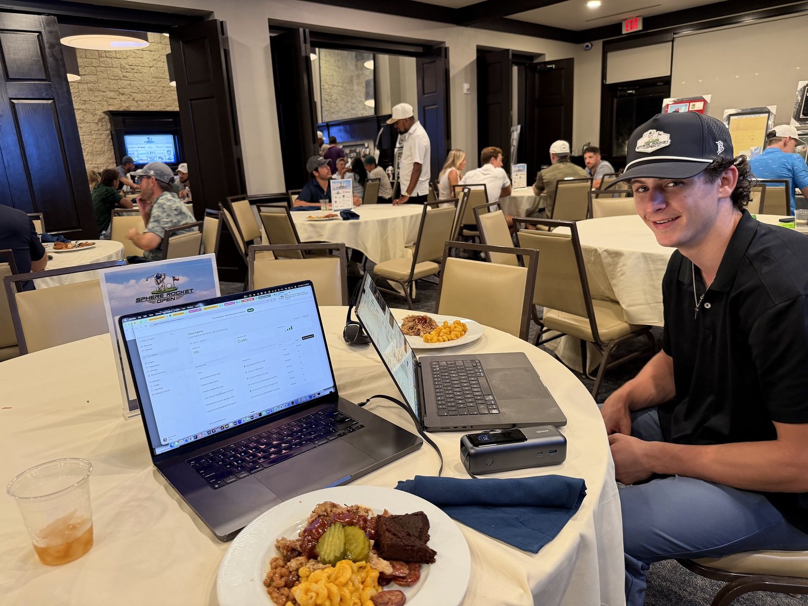 Jack Allard at lunch with a laptop open, checking on his agents during the Sphere Rocket Open