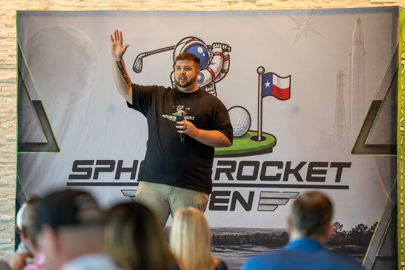 Justin Nelson speaking on stage at the Sphere Rocket Open