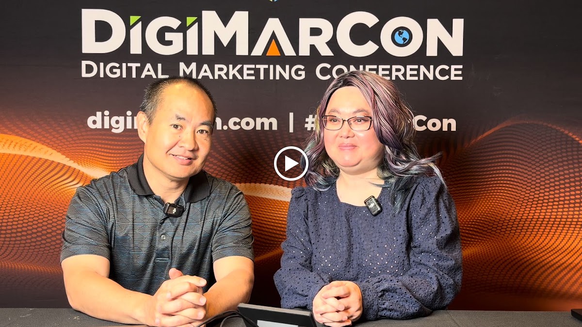 Liana Hosted. I Graded Lamont Brothers in Public. 1 Liana Ling and Dennis Yu seated with lapel microphones in front of a DigiMarCon backdrop