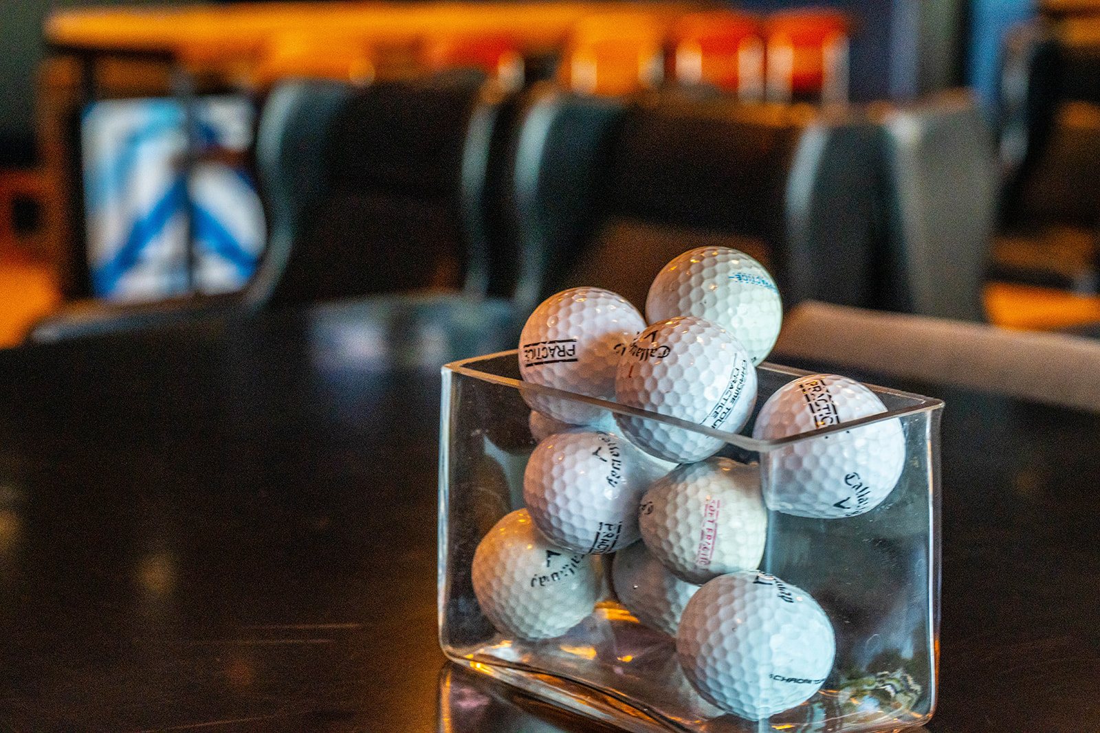 Golf balls in a glass box at the opening night of the Sphere Rocket Open at Cowboys Golf Club